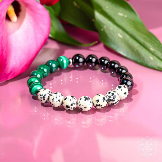 Dalmatian Jasper healing bracelet by Conscious Items featuring black and cream spotted stones on an elastic band.