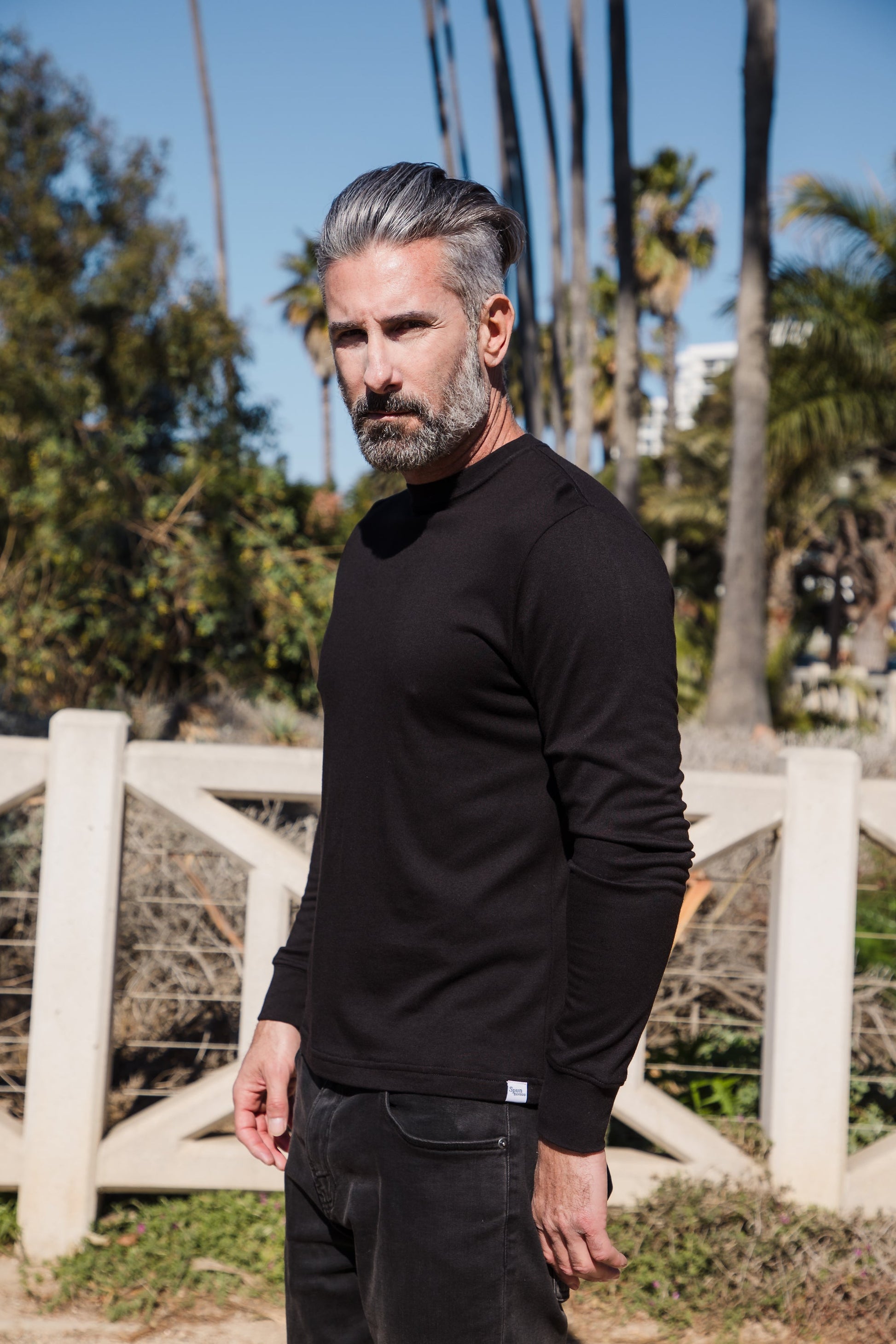 Black men's long sleeve T-shirt by Spun Bamboo made from bamboo viscose and organic cotton, displayed on a hanger.
