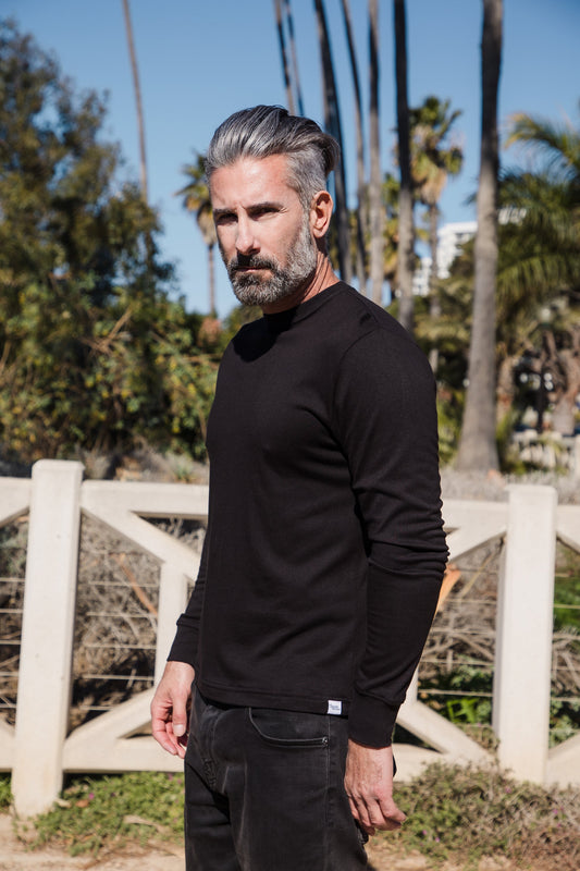 Black men's long sleeve T-shirt by Spun Bamboo made from bamboo viscose and organic cotton, displayed on a hanger.