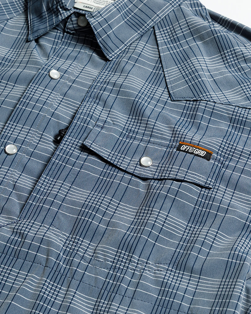 Short sleeve Deke SS shirt in Dusty Royal by Off The Grid Surplus, featuring a button-up design and casual fit in blue fabric.