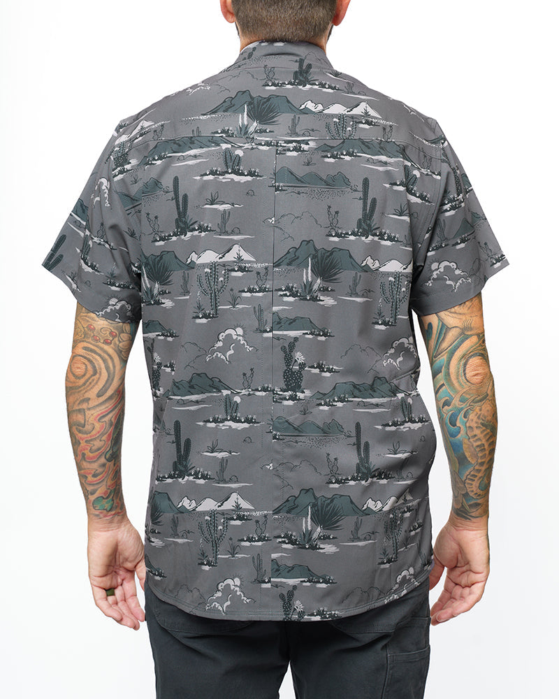 Dark grey short sleeve San Saba SS shirt by Off The Grid Surplus, button-up style, displayed on a hanger.