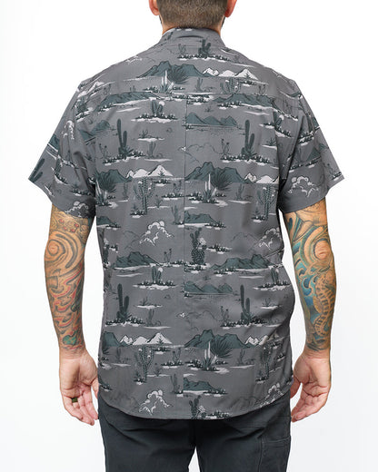 Dark grey short sleeve San Saba SS shirt by Off The Grid Surplus, button-up style, displayed on a hanger.