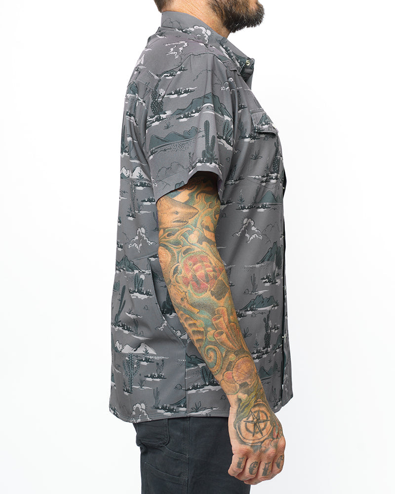 Off The Grid Surplus San Saba SS Shirt in Castlerock, dark grey short sleeve button-up shirt displayed on a hanger.