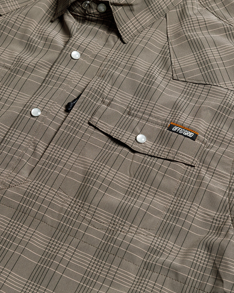 Off The Grid Surplus Deke SS Shirt in Beluga Brown, short sleeve button-up shirt displayed in green color.