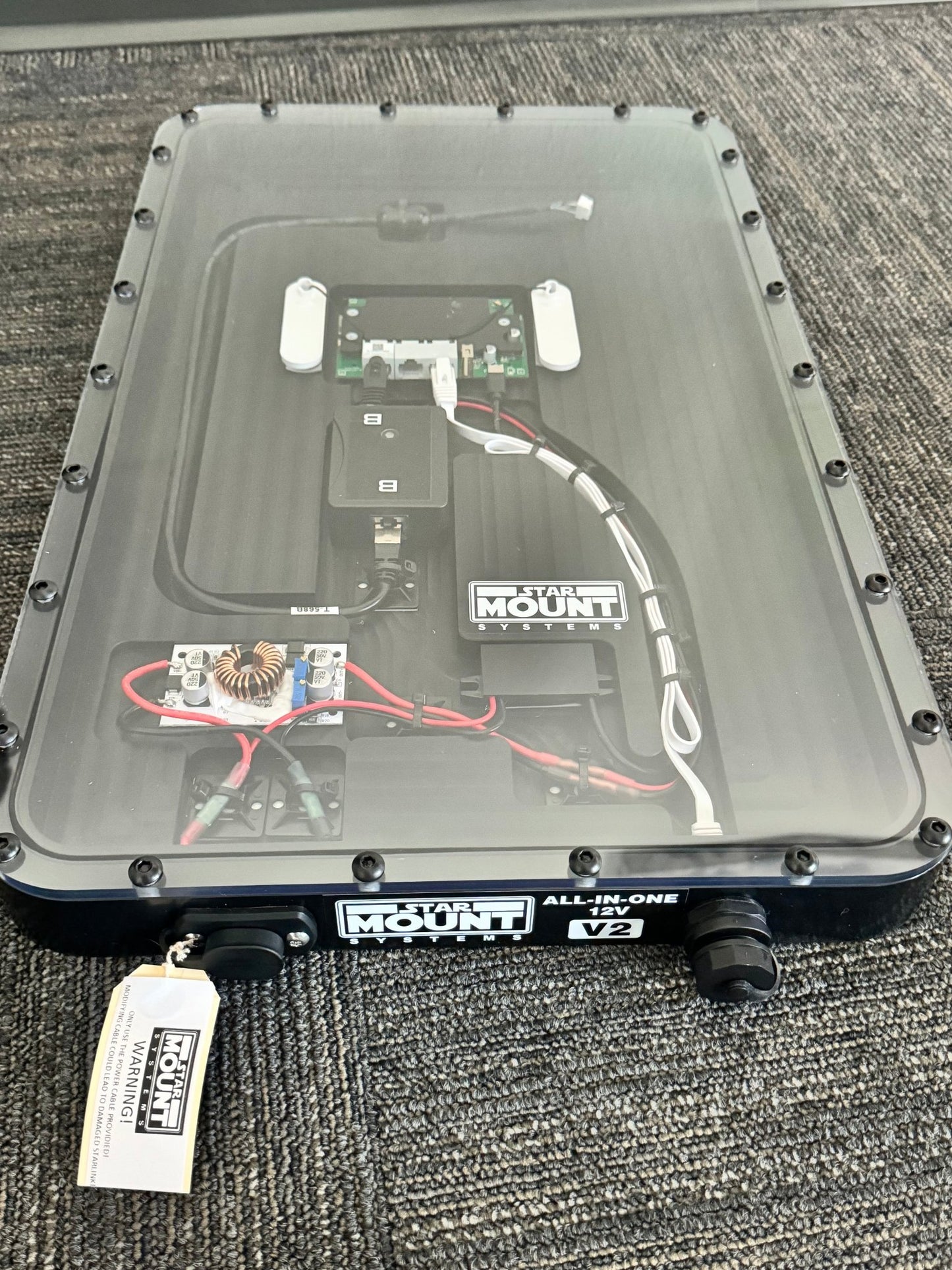 Black Star Mount Systems All-In-One 12V flat mount for Gen 2 Starlink, shown with clear lid and mounting hardware.