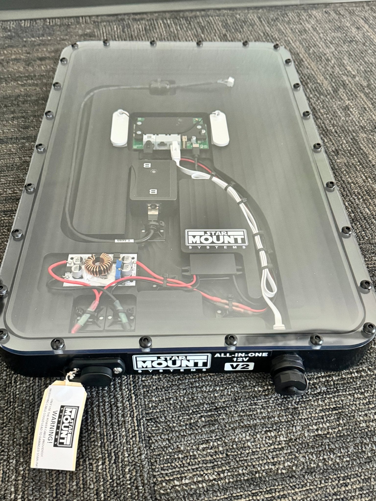 Black Star Mount Systems All-In-One 12V flat mount for Gen 2 Starlink, shown with clear lid and mounting hardware.