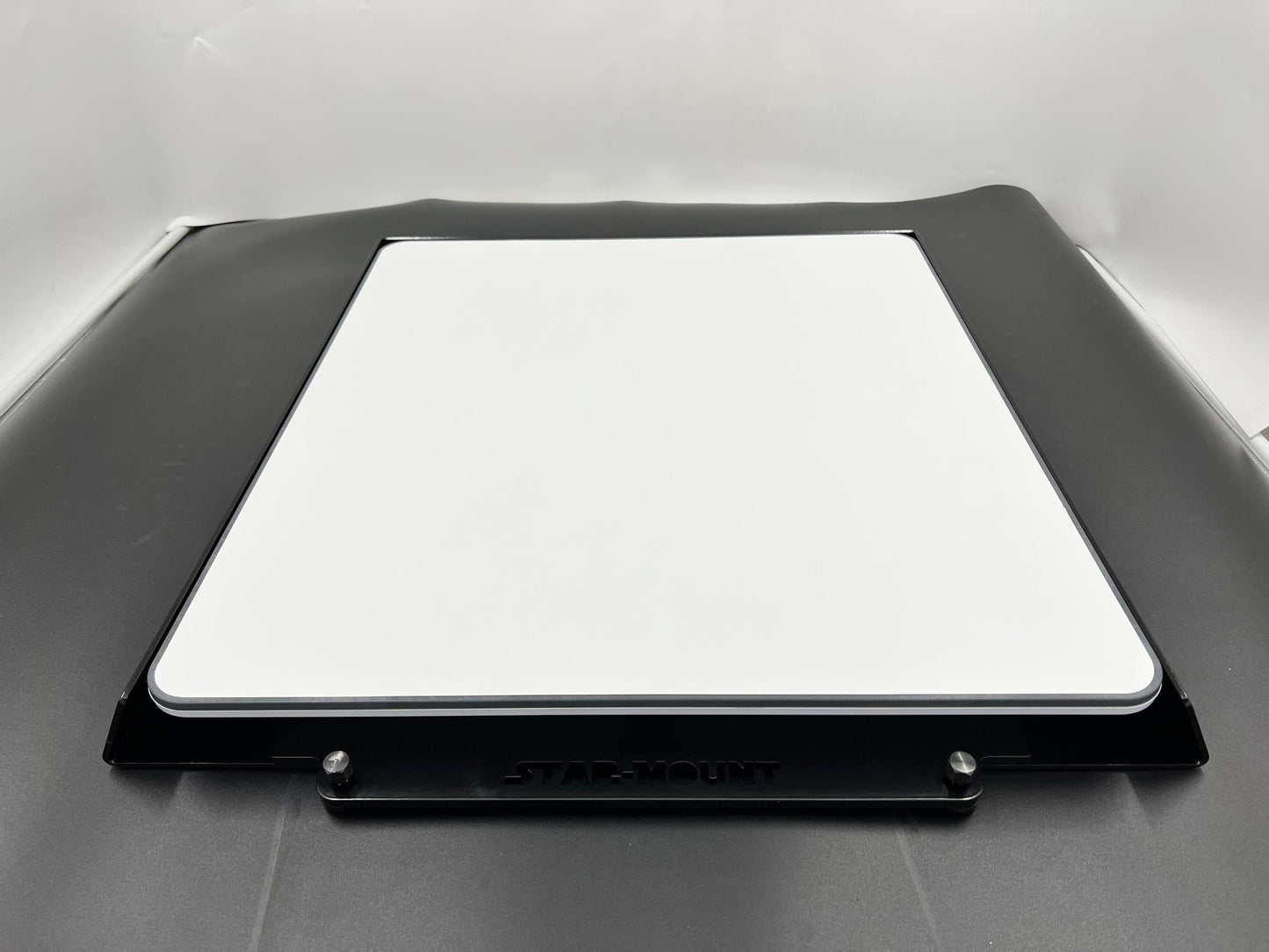 White quick-release mount for Starlink High Performance In-Motion Dish Gen 2 by Star Mount Systems on a mounting surface.