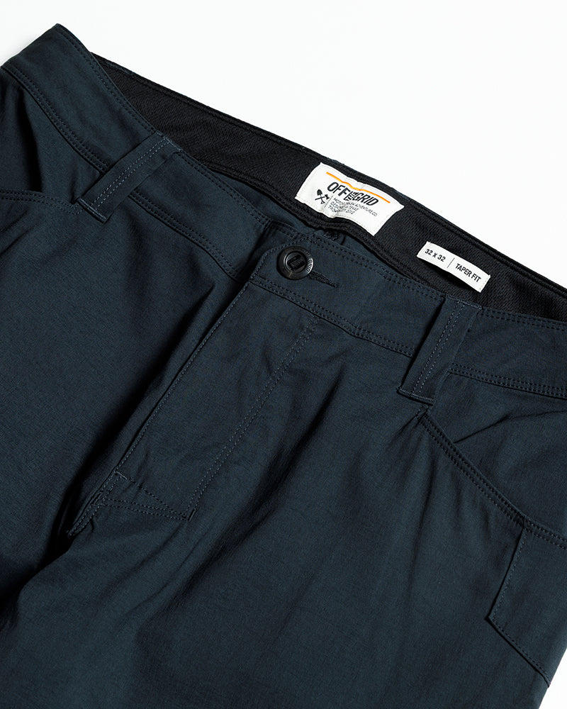 Off The Grid Surplus Lancer Taper Fit Pant in Vulcan Navy, showing the navy stretch pants with tapered design and waistband detail.