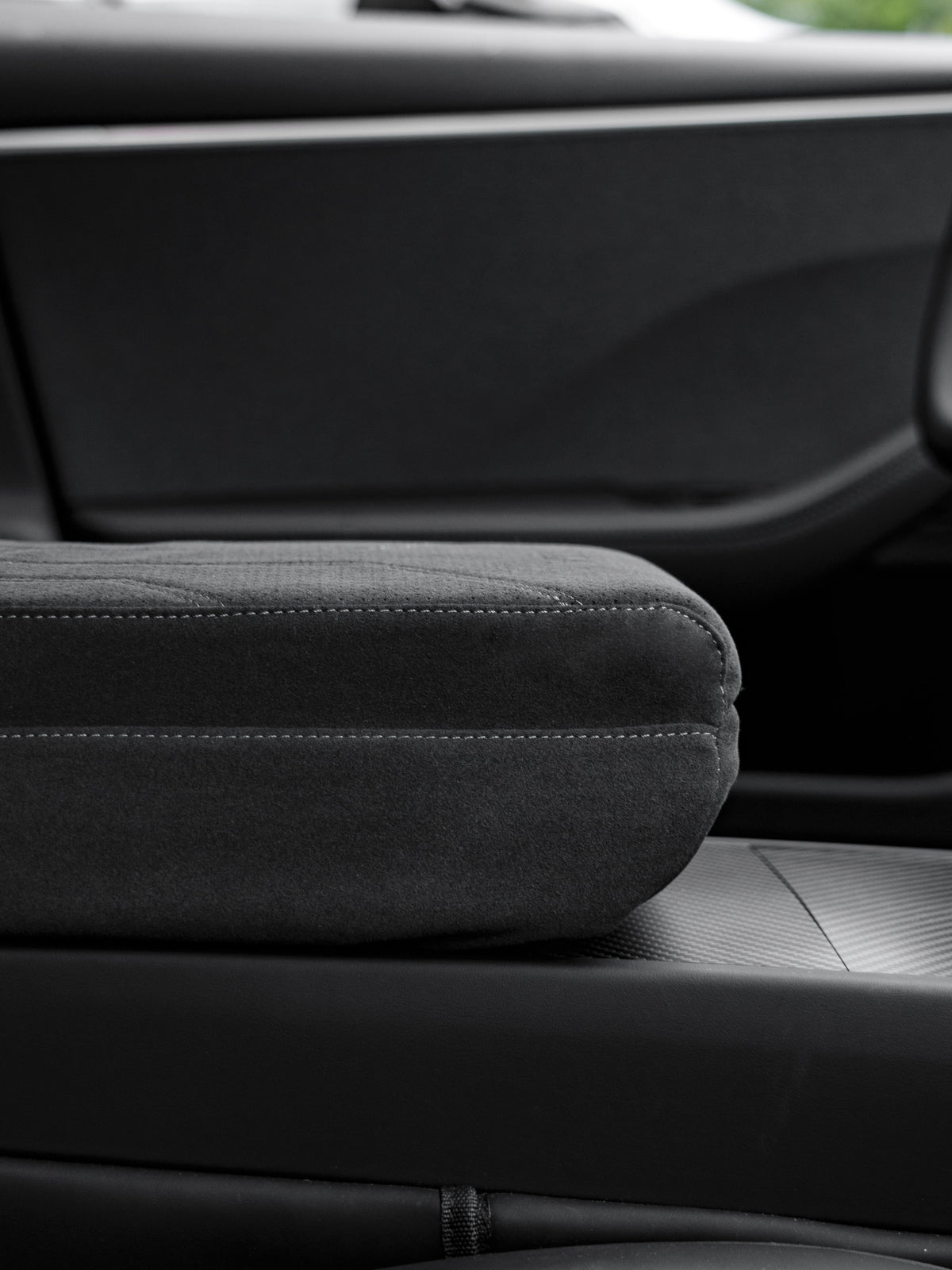 Suede armrest cover with raised pad and tissue box for Tesla Model Y Juniper and Model 3 Highland interior, by Tesery Official.