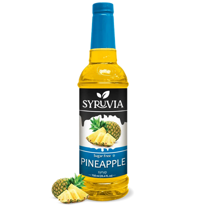 Bottle of Syruvia sugar-free pineapple syrup with a clear label, showing the golden-yellow liquid inside.