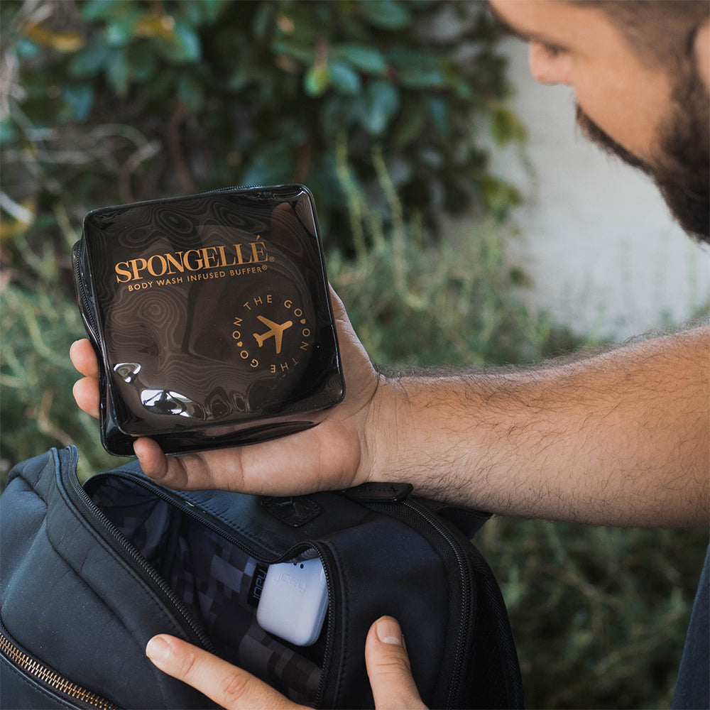 Black Spongellé travel case with zipper closure, designed for storing toiletries and travel essentials.