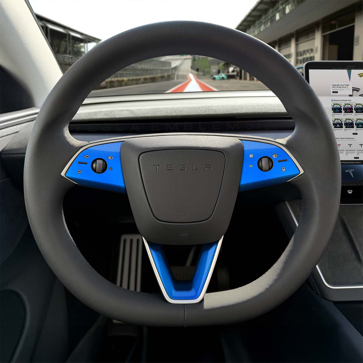 Tesla Model 3 steering wheel trim decal kit in gloss fire blue from 3M, includes three decals for Tesla Emblems.