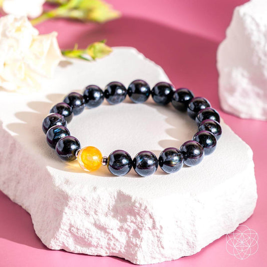 Deep healing bracelet featuring Arfvedsonite stones by Conscious Items, showcasing a stylish bracelet with dark, polished gemstone beads.