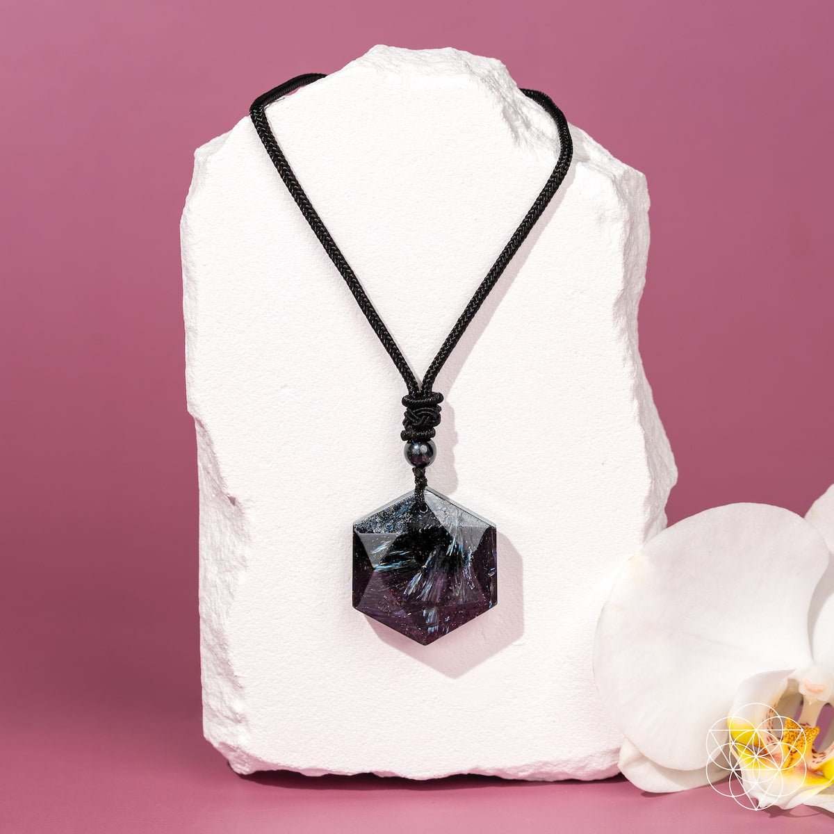 Deep healing Arfvedsonite pendant necklace by Conscious Items featuring a polished black gemstone pendant on a silver chain.