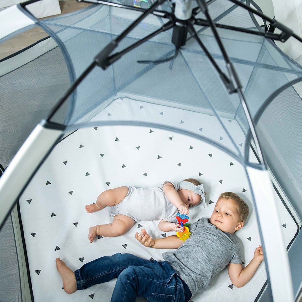 Pop 'N Go Playpen by The California Beach Company LLC, in cosmic gray, showing its portable design and mesh sides for easy visibility.