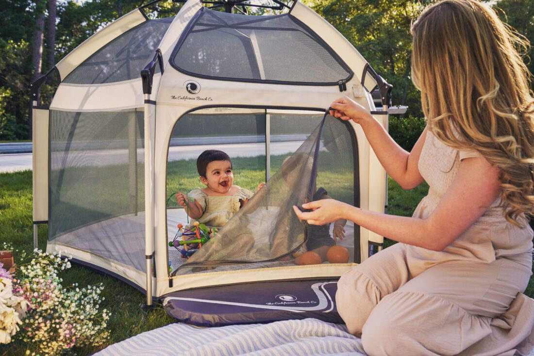 Pop 'N Go Playpen in cosmic gray by The California Beach Company LLC, showing its portable design and mesh sides.
