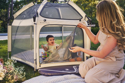 Pop 'N Go Playpen in cosmic gray by The California Beach Company LLC, showing its portable design and mesh sides.