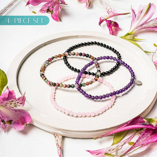 Set of four crystal bracelets from the At Ease jewelry collection by Conscious Items, featuring natural stone designs.