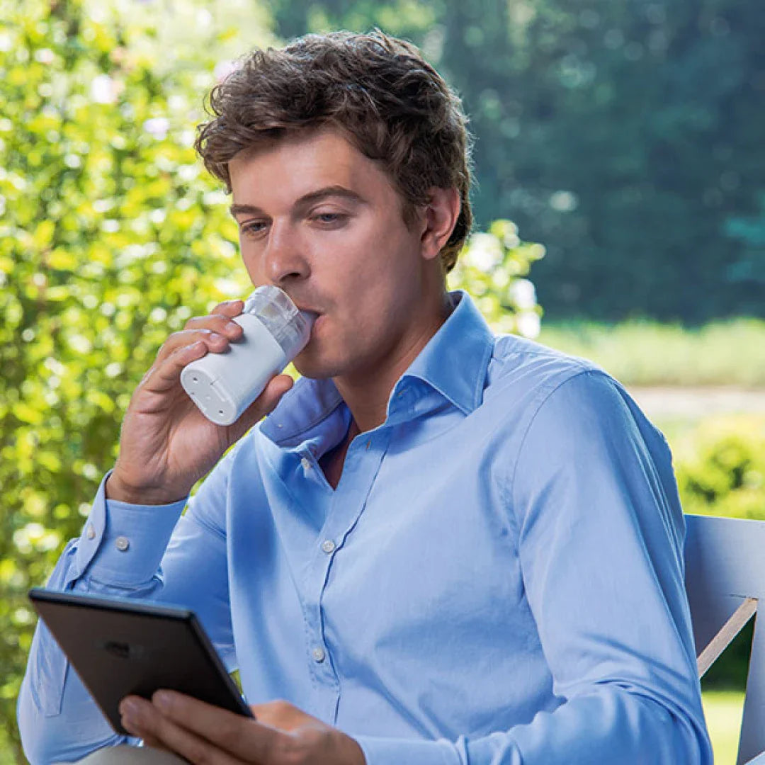 Omron NE-U100 Portable MicroAir Nebulizer showing compact design and mouthpiece for respiratory therapy.