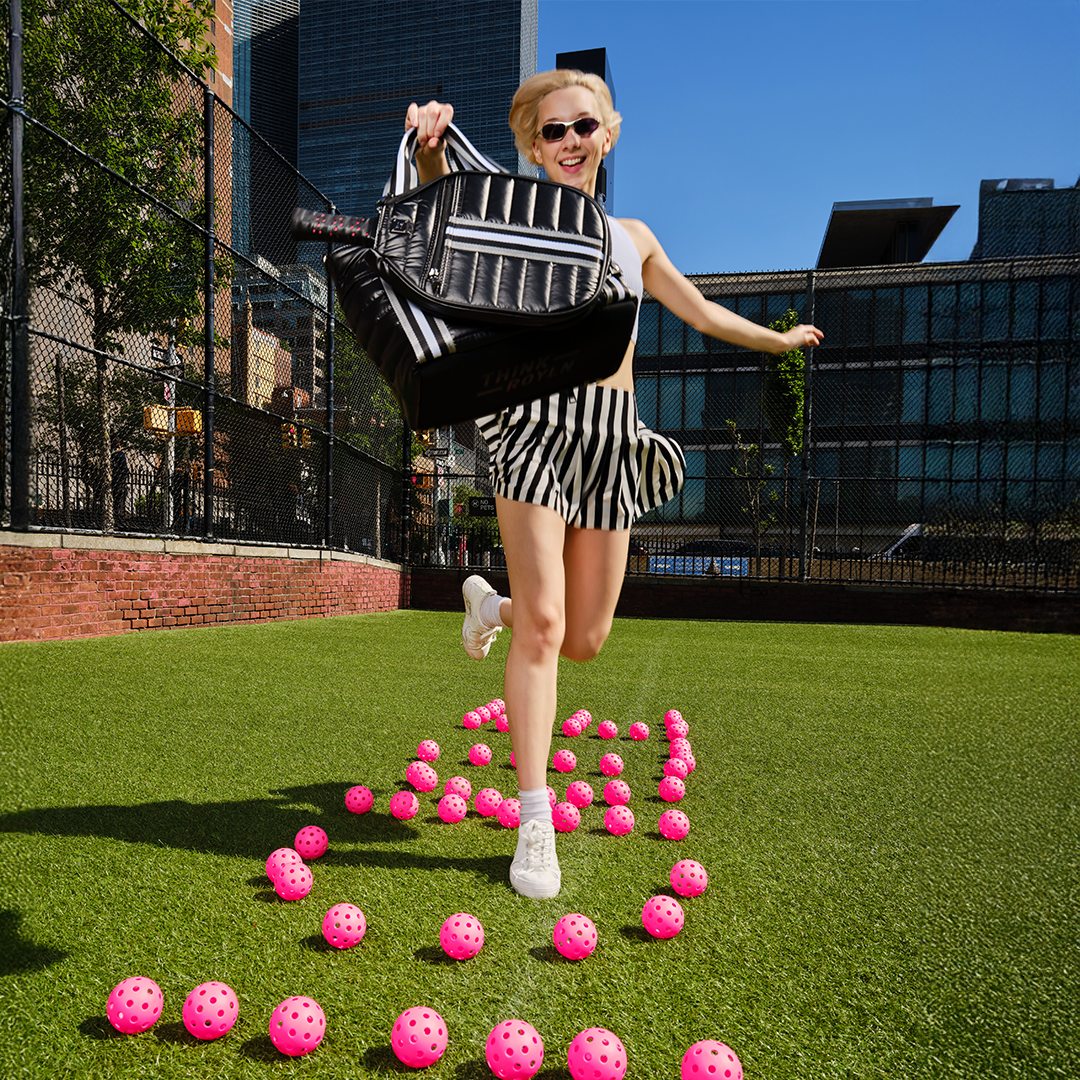 Think Royln Ace of the Court pickleball bag in sleek black patent with multiple compartments for gear storage.
