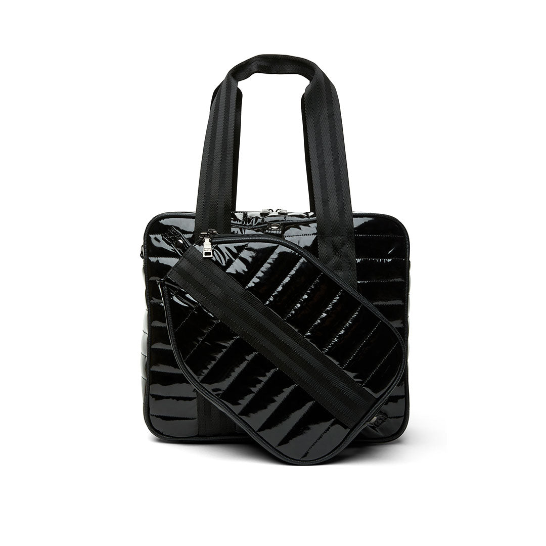 Think Royln Sporty Spice pickleball bag in white patent leather with sporty design and multiple compartments for accessories.