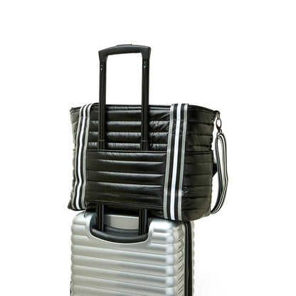 Black patent Love Royln tennis bag by Think Royln with sleek design and spacious compartments, perfect for sports and casual use.