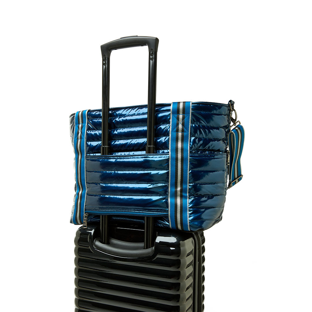 Black patent Love Royln tennis bag by Think Royln with sleek design and top handles for stylish sports storage.