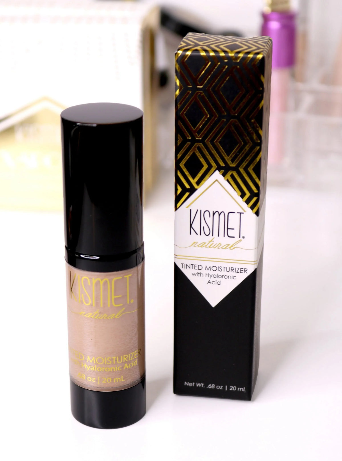 Kismet natural tinted moisturizer with hyaluronic acid, showing smooth, medium-toned application on skin for a dewy finish.