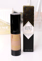 Kismet Natural Tinted Moisturizer with Hyaluronic Acid in a tinted tan shade, showing smooth, lightweight formula on the skin.