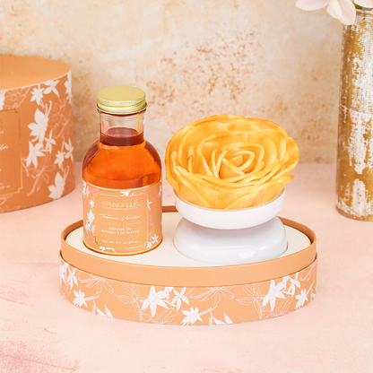 Spongellé Tobacco Vanilla Private Reserve diffuser with a sleek bottle and reed sticks for home fragrance and aromatic ambiance.