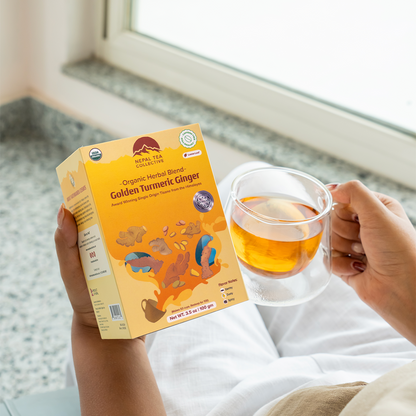 Organic Golden Turmeric Ginger blend by Nepal Tea, showing a vibrant mix of turmeric and ginger ingredients in a natural setting.