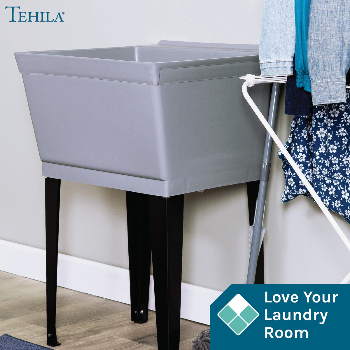 Grey Tehila Standard freestanding utility sink with black legs, no supply lines visible, designed for laundry or utility rooms.