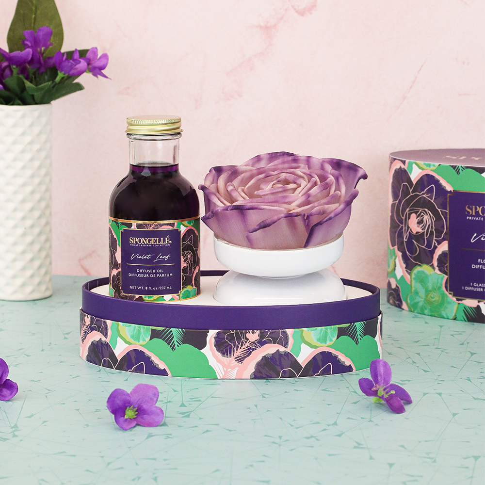 Spongellé Violet Leaf Private Reserve diffuser with glass bottle and reed sticks for home fragrance.