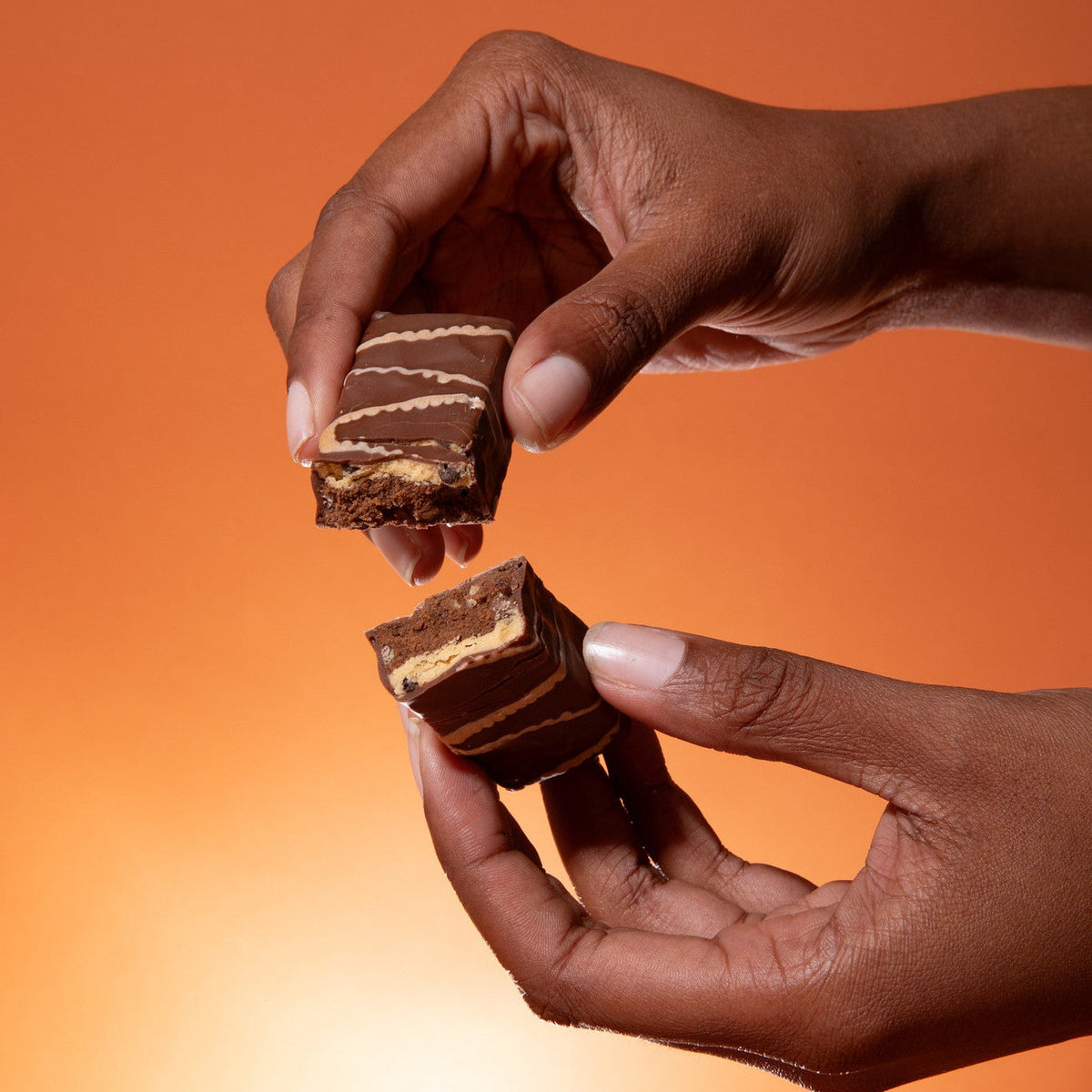 Biocare high protein chocolate caramel bar showing the bar with chocolate, caramel layers, and packaging in the background.