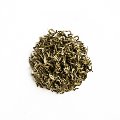 Organic White Prakash tea by Nepal Tea, showing fresh, white tea leaves in a natural, appealing arrangement