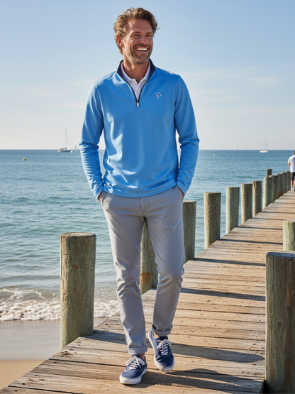 Light blue and navy White Water Life Montauk quarter zip midweight comfort sweatshirt laid flat on a wooden surface.