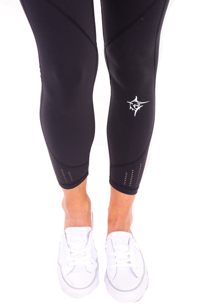 Black HydroFlex Cut Out Leggings by White Water Life featuring mesh panels and a sleek, athletic fit for active wear.