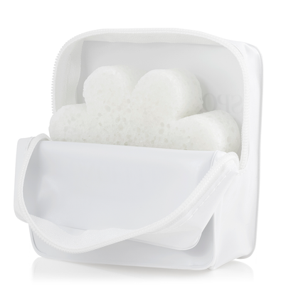 White Spongellé travel case with zipper closure, compact shape, designed for storing toiletries and travel essentials.