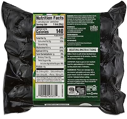 Whole Foods Market Organic Mild Italian Chicken Sausage, 12 oz, cooked and sliced on a plate with herbs and vegetables.