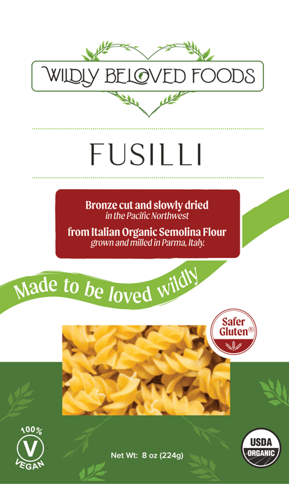 Dried vegan fusilli pasta from Wildly Beloved Foods, showing coiled pasta noodles ready for cooking.