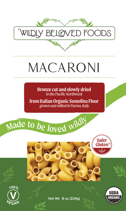 Vegan dried macaroni pasta by Wildly Beloved Foods, classic pasta shape in a close-up image.