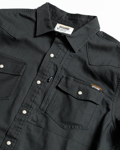 Off The Grid Surplus Earl Denim Shirt in vintage black, long sleeve woven denim shirt displayed on a hanger.