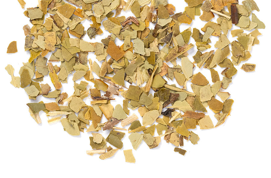 Loose leaf Yerba Mate herbal tea from Novel Tea Book Shop, showing fresh green yerba mate leaves in a natural setting.