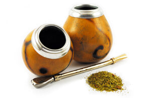 Loose leaf Yerba Mate herbal tea in a jar from Novel Tea Book Shop, showing green tea leaves for traditional South American infusion.