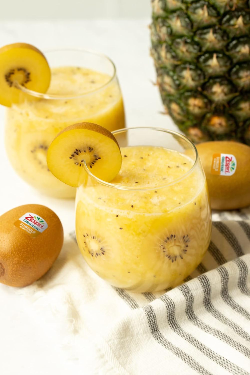 Zespri Organic Gold Kiwis in a 1 lb bunch, showing vibrant yellow skin and fresh, ripe fruit ready to eat.