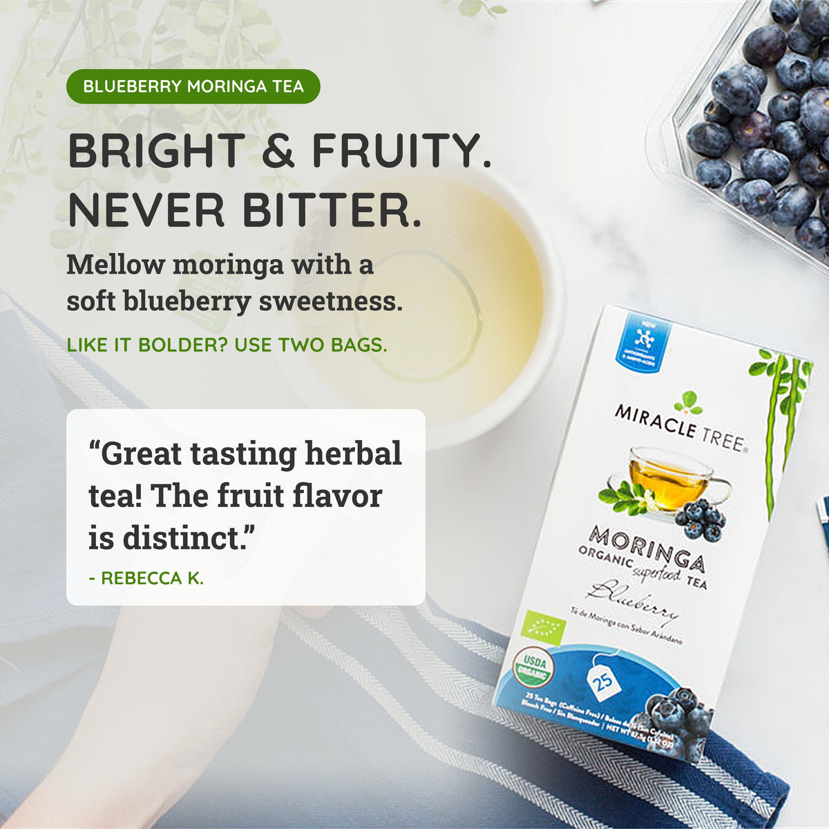 Organic Moringa Tea with Blueberry, caffeine-free herbal tea by Miracle Tree, featuring fresh blueberries and vibrant tea leaves.