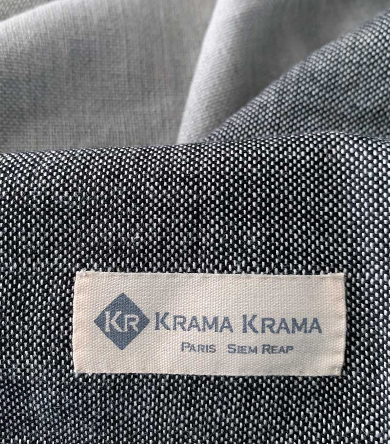 Black Krama Jeans made from traditional Krama fabric by Krama Krama, showing the detailed woven textile in a close-up view.