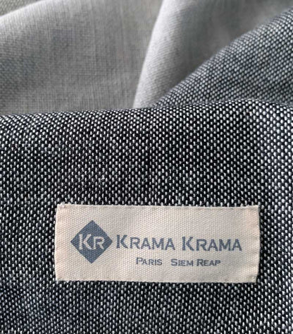 Black Krama Jeans made from traditional Krama fabric by Krama Krama, showing the detailed woven textile in a close-up view.